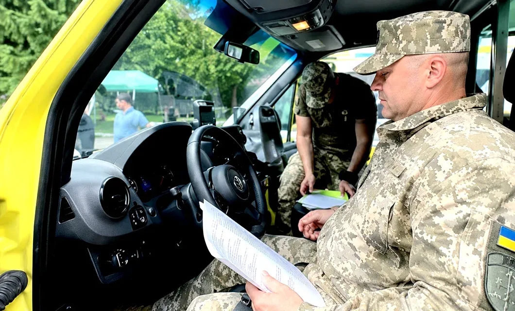 Reviewing documentation inside one of the five ambulances delivered to Ukraine.