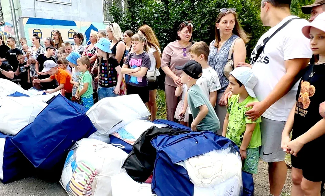 Families gathering to receive humanitarian aid supplies.