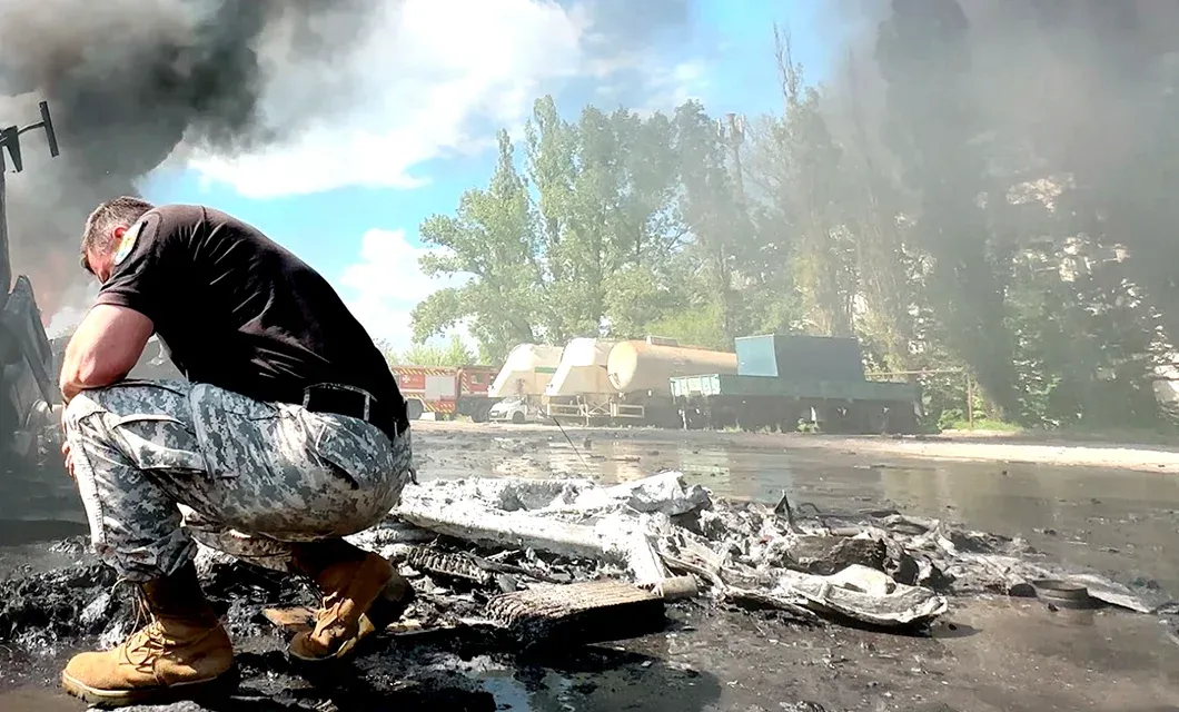 Gennady Mokhnenko, founder of the Pilgrim Children's Home, at the site of a Russian missile strike beside a truck driver who was killed on May 15, 2026.